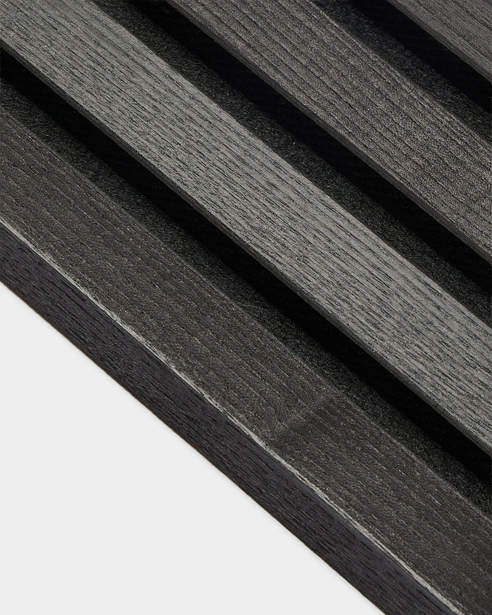 Imagem de perto da lamela terminal WoodUpp com acabamento em freixo Black, com 2,2 cm de espessura, concebida para instalações Akupanel Painel acústico ou para utilização com uma estrutura em MDF.