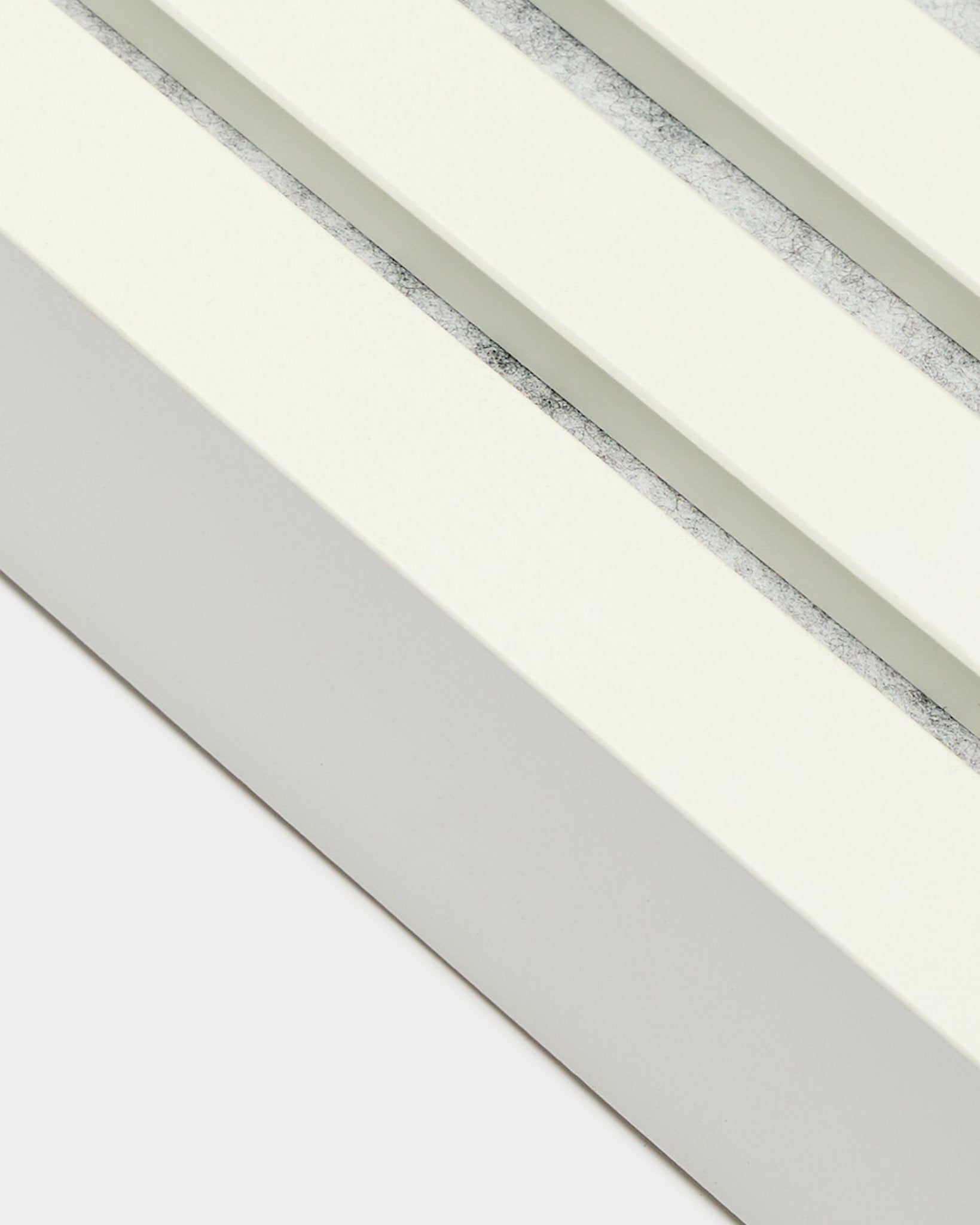 Vista aproximada da lâmina final WoodUpp em Snow, com 6,7 cm de largura, moldura em MDF, dupla ranhura e acabamento texturado em grey para instalação de parede Akupanel Painel acústico.