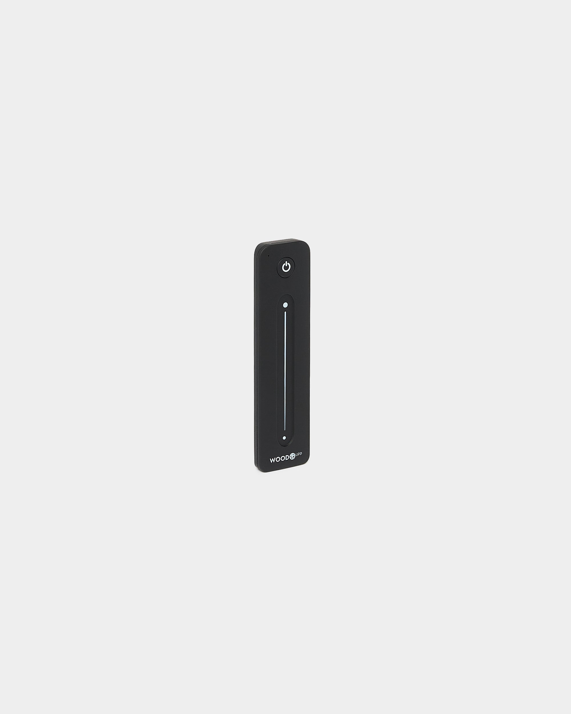 Comando Slim black WoodUpp Lumi para fitas LED, com vertical slider tátil e botão de ligar/desligar, compatível com Philips Hue, apresentado sobre fundo branco.