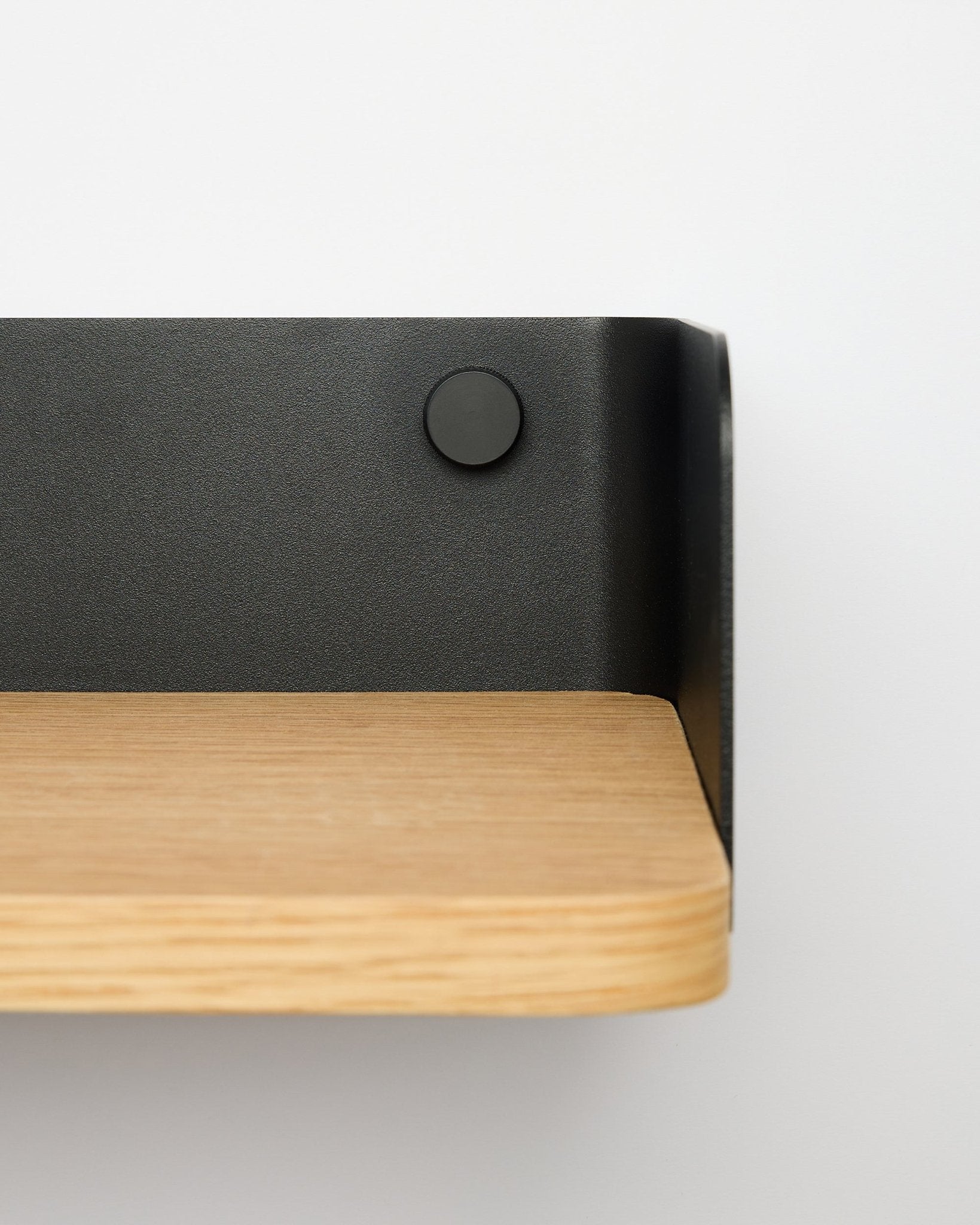 Estante Linn Bookshelf da WoodUpp em natural oak, com 55,9 cm de largura, com suporte metálico black, montada numa parede branca; vista de perto do lado direito.