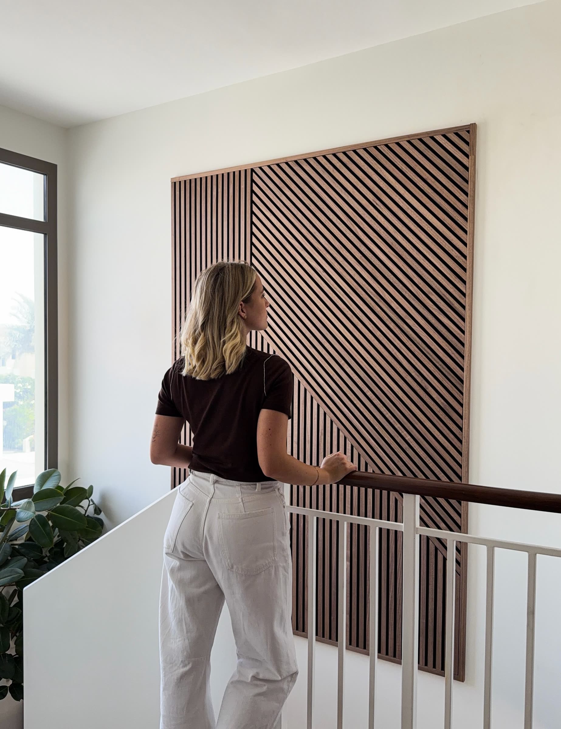 Framed Akupanel slat artwork with slats at several angles on a stairwell landing
